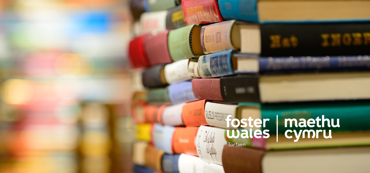 Foster wales hero image of a stack of books