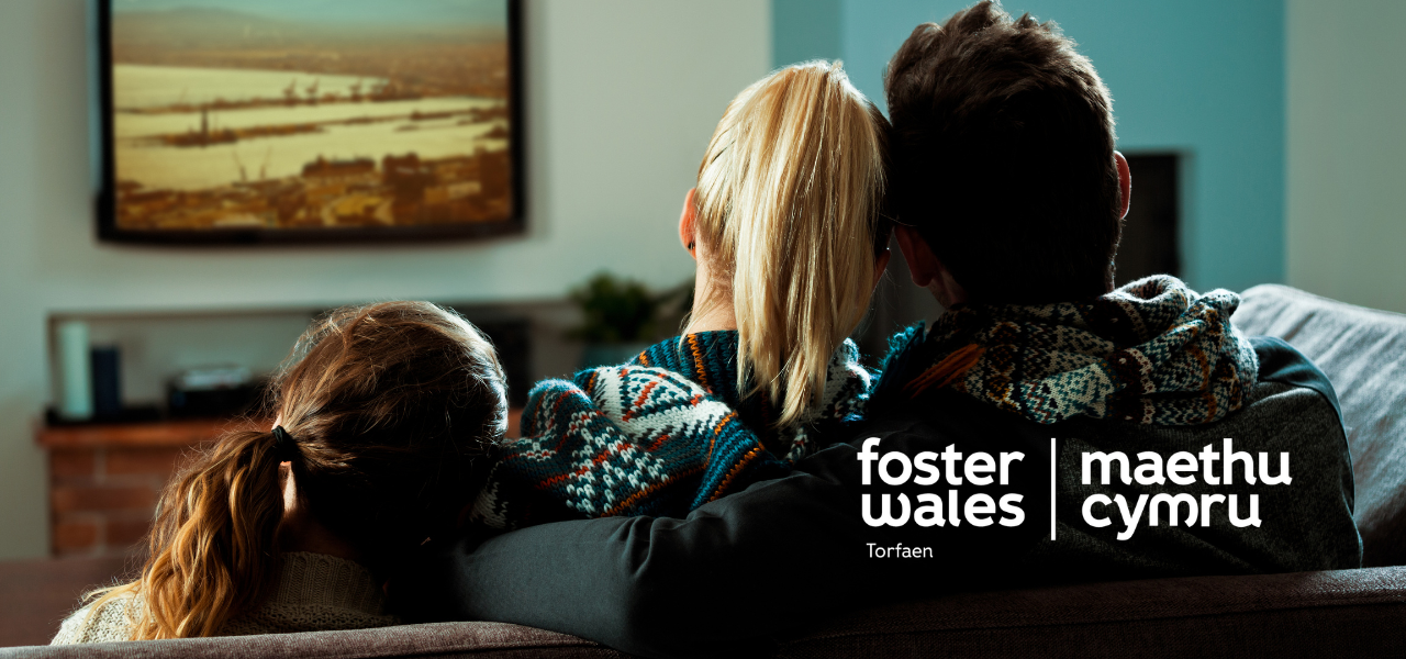 foster wales hero image of family sat on sofa